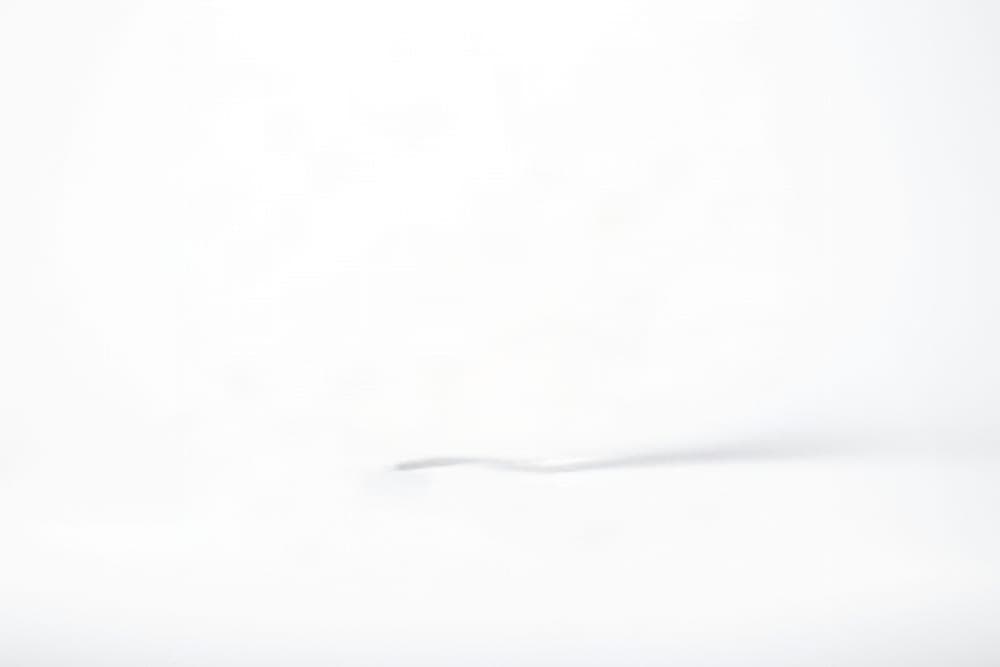 Plain background with text: background layer with the subject removed and the area rebuilt by AI